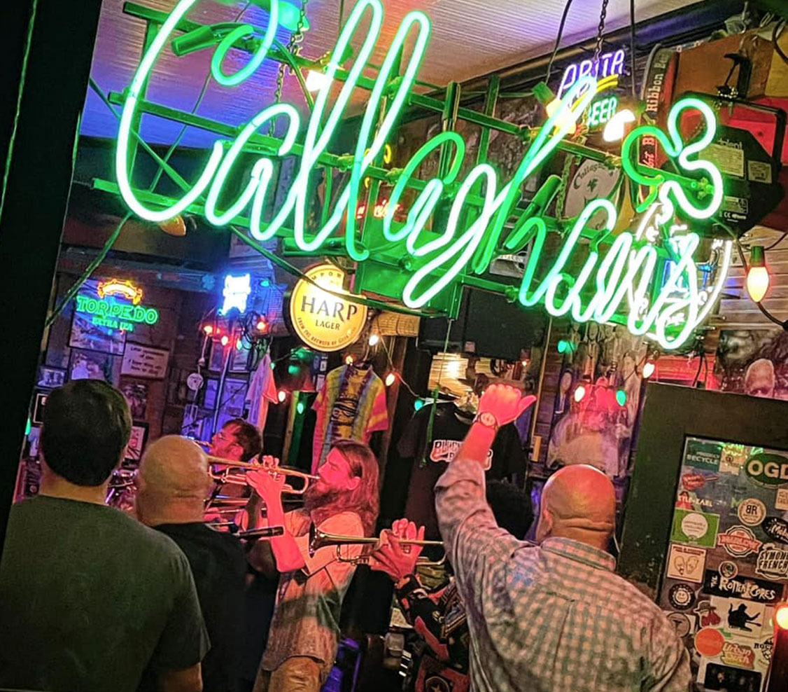 callaghans neon sign outside of irish pub